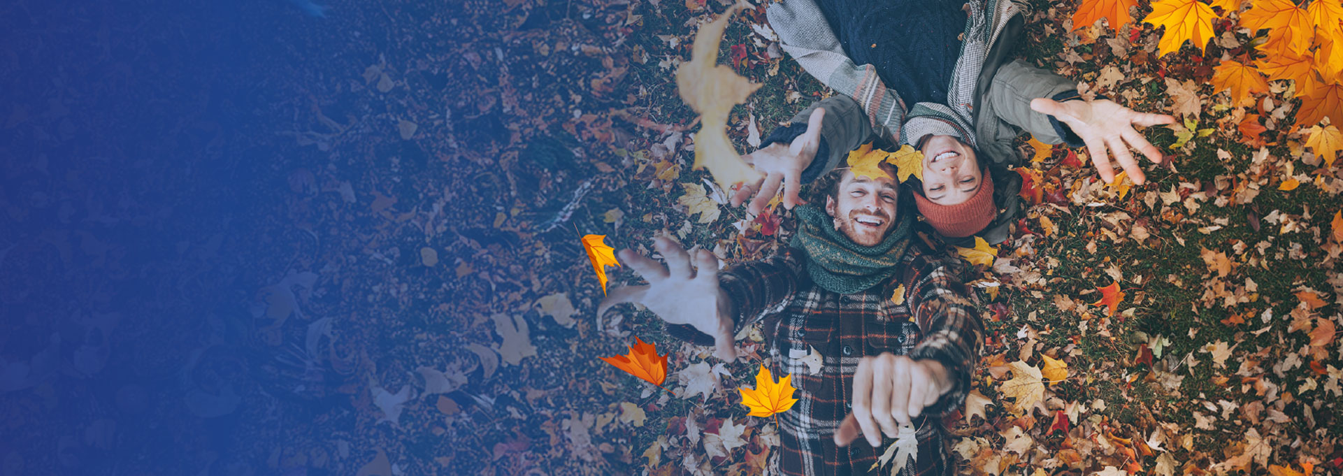 couple playing in fall leaves representing home and car insurance