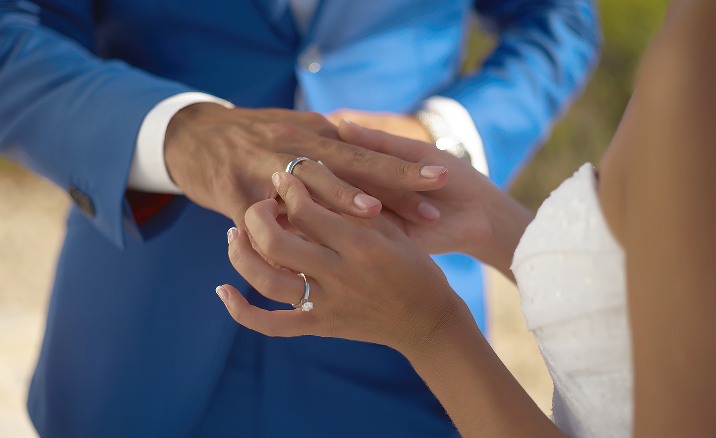 Bride and groom exchange wedding rings at wedding ceremony
