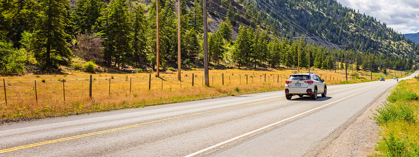 Car driving on a BC highway, representing ICBC Autoplan and optional car insurance coverage with Western Financial Group.