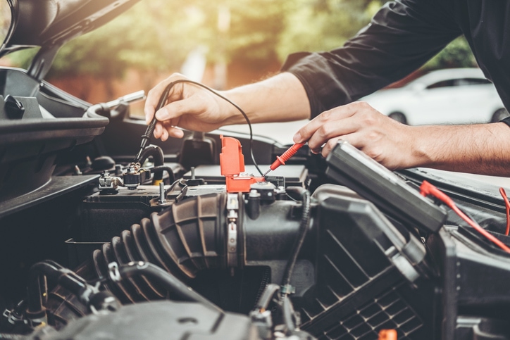 Mechanic working on a car battery