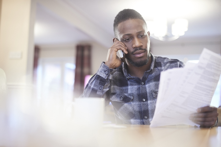 Young man looking at auto insurance documents