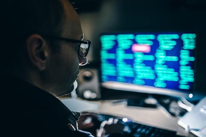 Man looking at computer analyzing data 