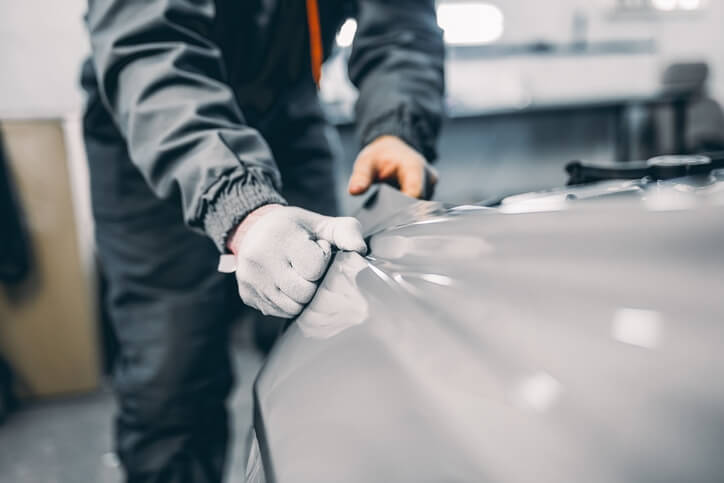 Mechanic fixes a car bumper