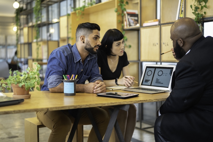 Young couple receiving financial advice.