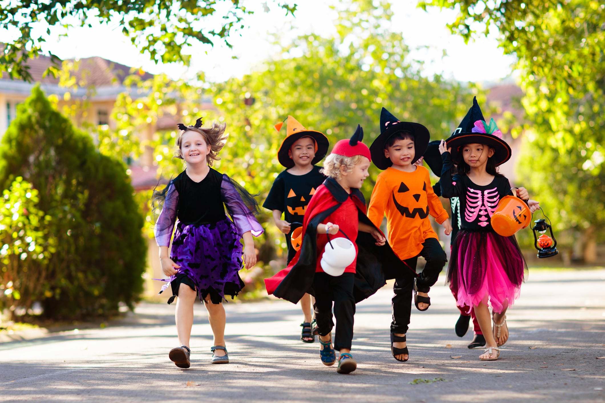 A group of children dressed in Halloween costumes ready to go trick-or-treating