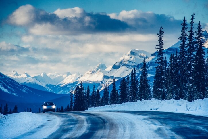 Car driving on a winter road in the mountains