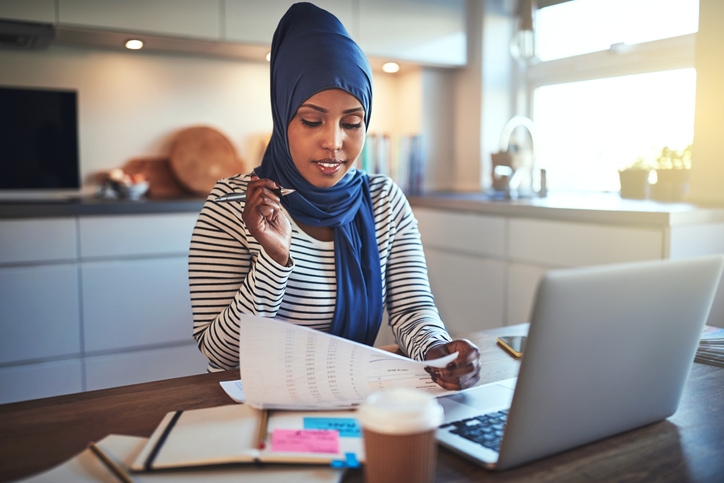 Young woman works at home on her laptop