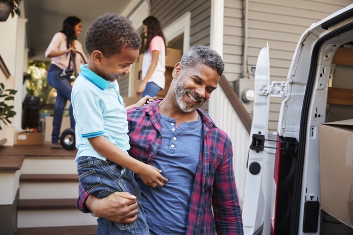 Children helping family moving into their new home