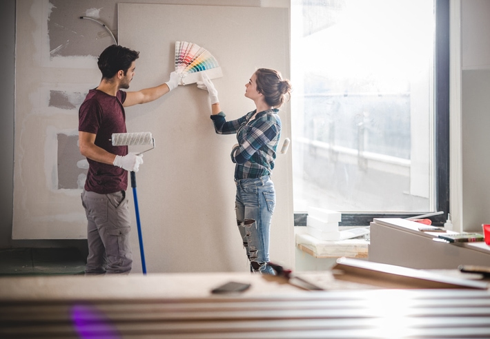 Young couple choosing paint colours for their renovations