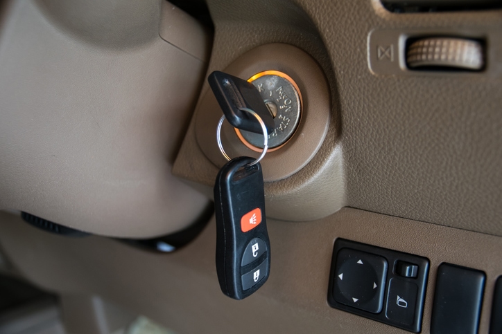 A set of car keys left in the ignition of a car