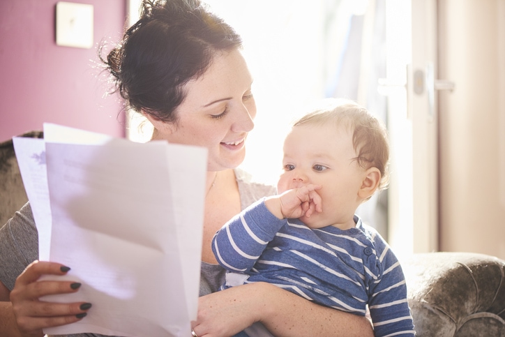 Young mother and baby look at a life insurance policy