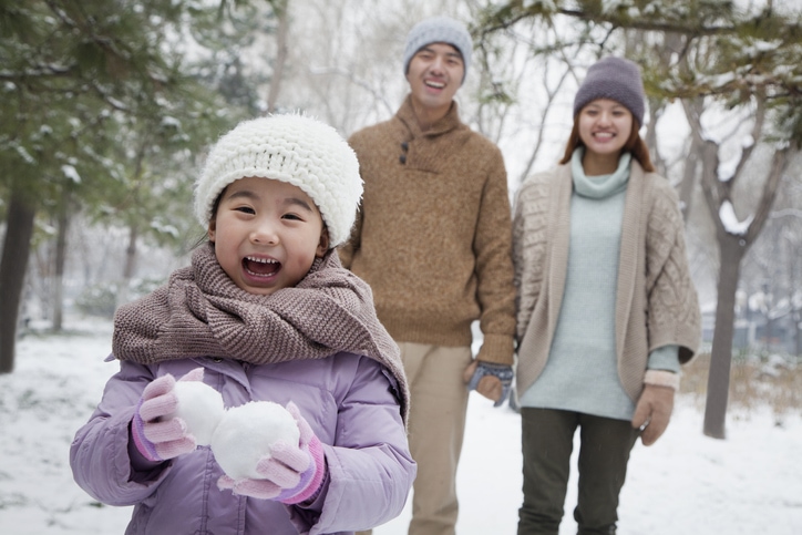 Young family walking outside in the snow.