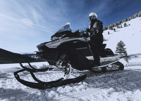 Person-riding-snowmobile-down-a-hill.jpg