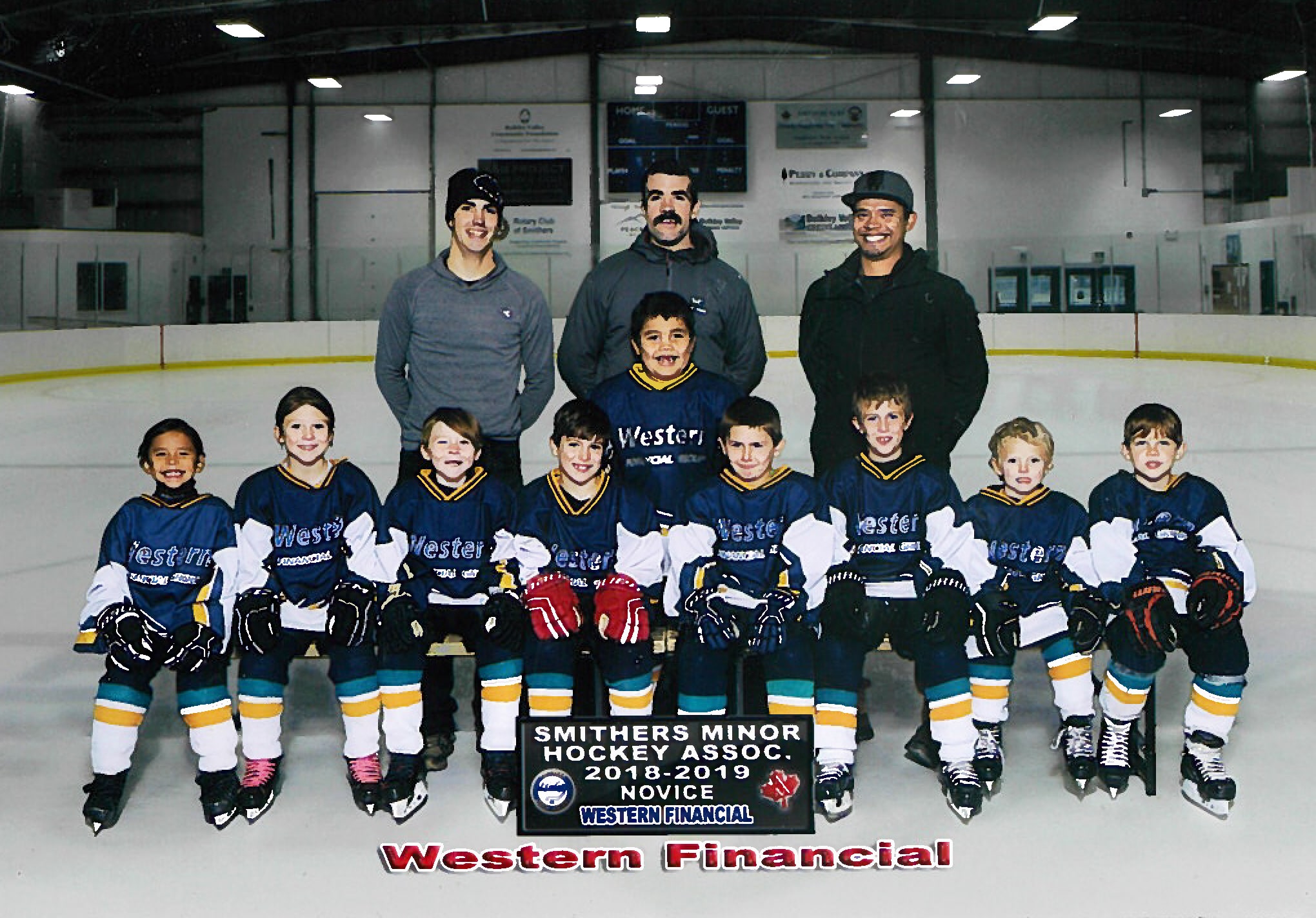 The 2018/19 Smithers Minor Hockey Association novice team poses with coaching staff in the community rink