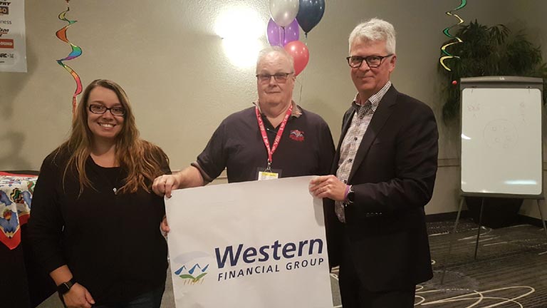 Western Financial Group team hands over the Western Financial Group banner to balloon pilot Bill Whelan