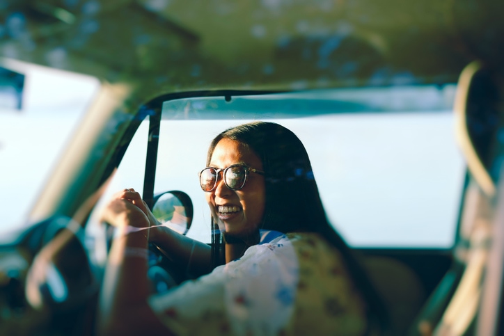 Young women enjoying test driving a car.