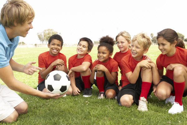 Happy kids learning about soccer