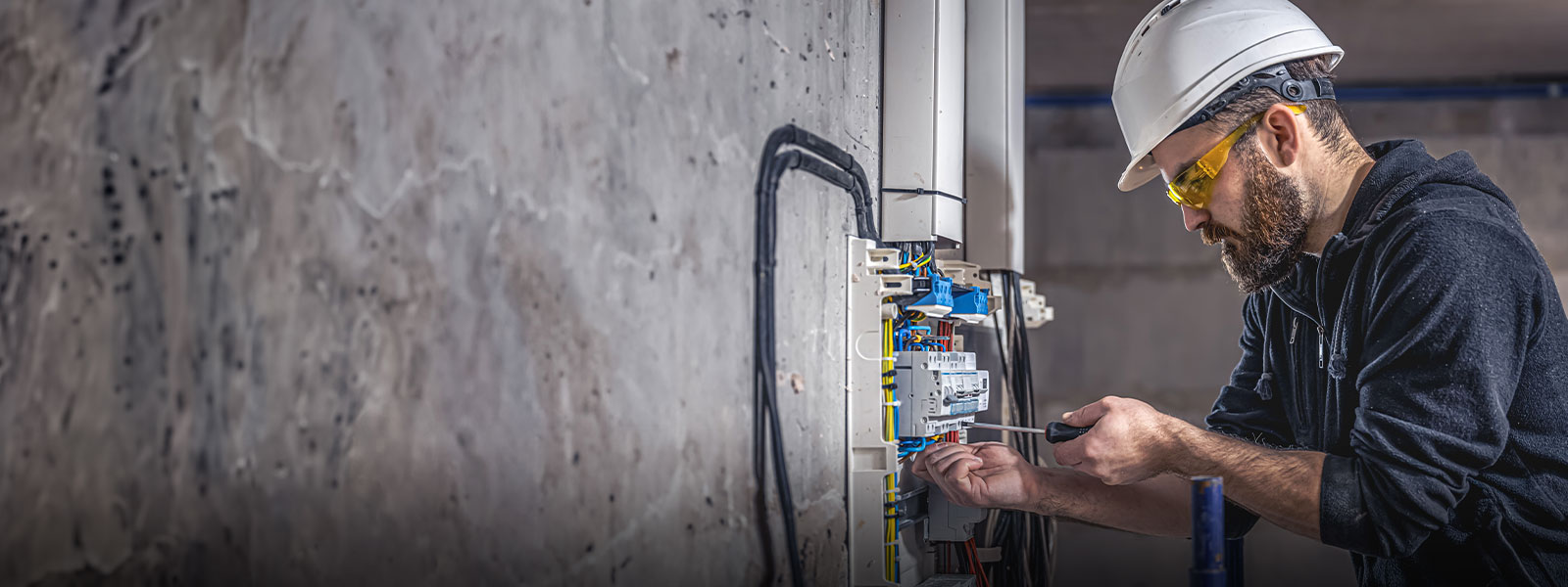 Alberta contractor working on electrical panel—representing reliable business insurance coverage for trades, services, and commercial operations across the province